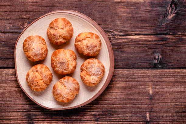 istock Homemade profiteroles with powdered sugar. 1359549000