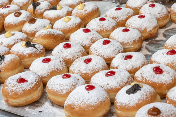 istock Sufganiot traditional jelly doughnut , bismark covered with powdered sugar eaten during the Hannukah holiday at the Mahane Yehuda market in Jerusalem 1359549921