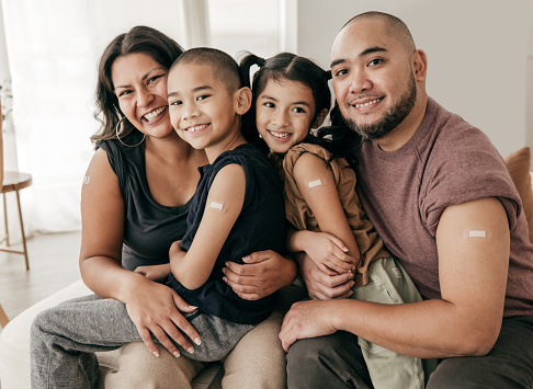 Vaccinated family portrait - four people with vaccine
