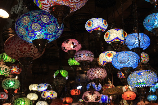 A bunch of colorful Moroccan pendant lamps hanging down in Granada, Spain.