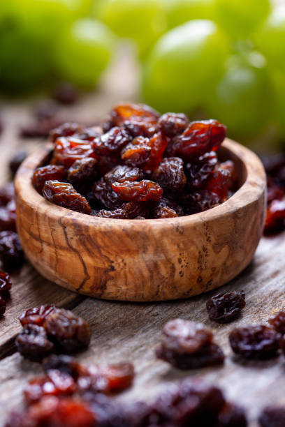 istock Raisins and grapes - wooden bowl 1359551693
