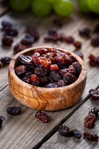 istock Raisins and grapes - wooden bowl 1359551776