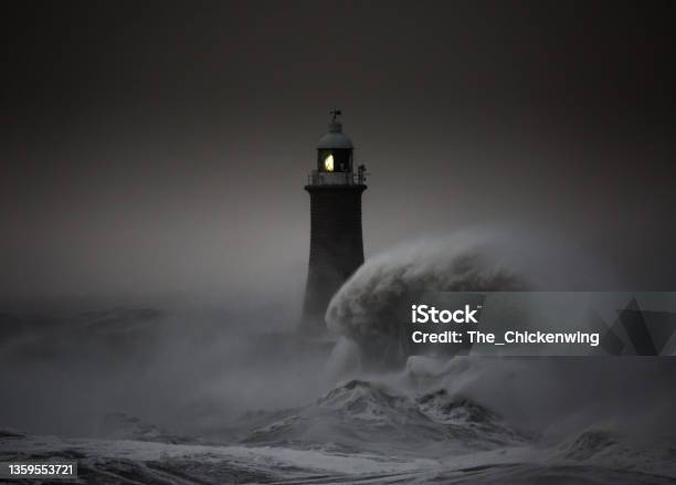 Storm Arwen Batters The Coastline At Tynemouth England With Giant Waves Crashing Against The Lighthouse In The Gale Force Winds Stock Photo - Download Image Now