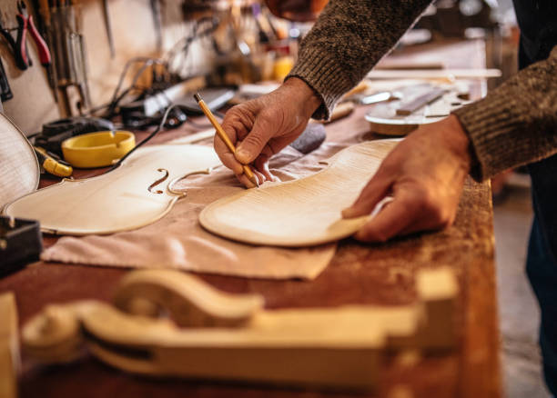 istock senior craftsman making  the violin 1359555463