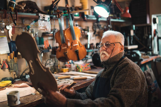 istock senior craftsman making  the violin 1359555999