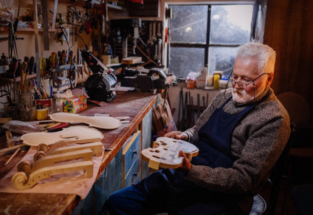 istock senior craftsman making  the violin 1359556035