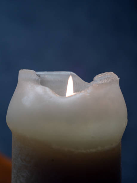 istock Burning candle in the dark close-up 1359556085