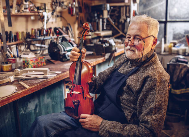 istock senior craftsman making  the violin 1359556091