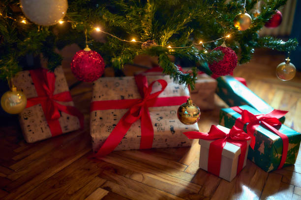 istock Wrapped christmas gifts under the tree 1359556359