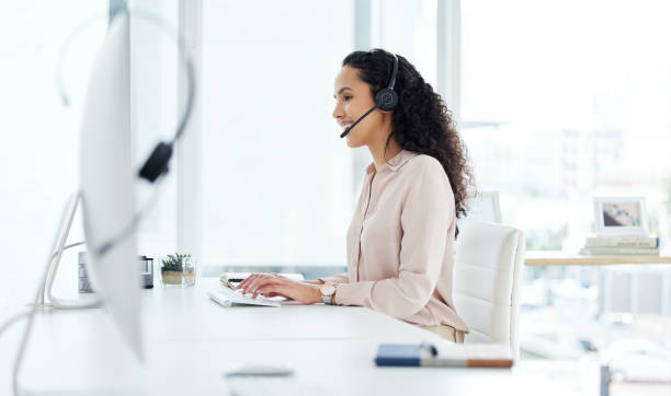 istock Shot of a young call centre agent working on a computer in an office 1359556704