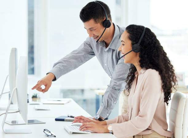 istock Shot of two call centre agents working together on a computer in an office 1359557260