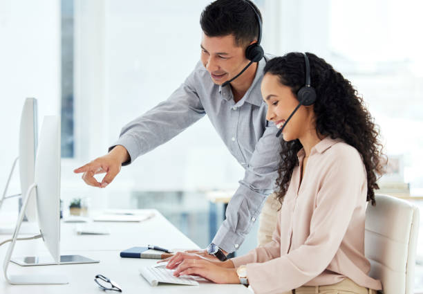 istock Shot of two call centre agents working together on a computer in an office 1359557261