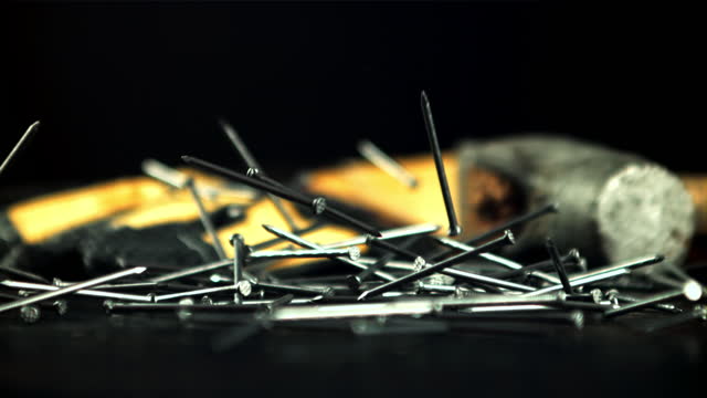 Nails fall on the table. Filmed is slow motion 1000 fps.