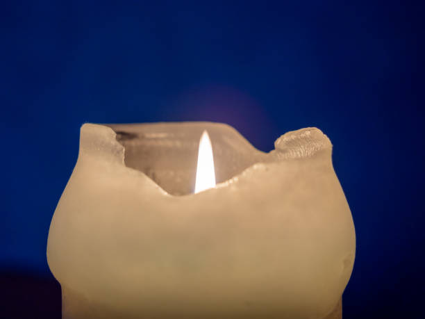 istock Burning candle in the dark close-up 1359557679
