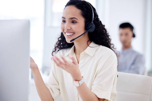 istock Shot of a young call centre agent working on a computer in an office 1359557722