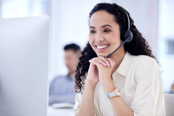 istock Shot of a young call centre agent working on a computer in an office 1359557726