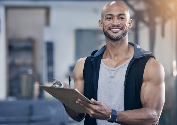 istock Portrait of a muscular young man writing notes on a clipboard while working in a gym 1359558763