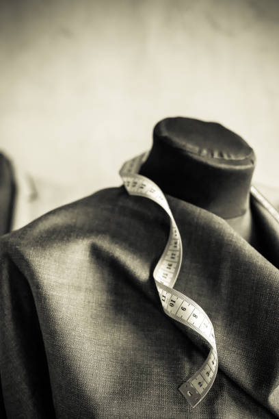 Cloth fabric on tailor mannequin. Concept of clothes atelier workplace