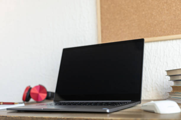 istock Laptop and notebook on table in office.  Workplace for online study 1359561262
