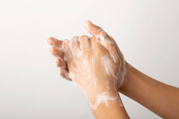 istock Girl washing hands with soap 1359562282