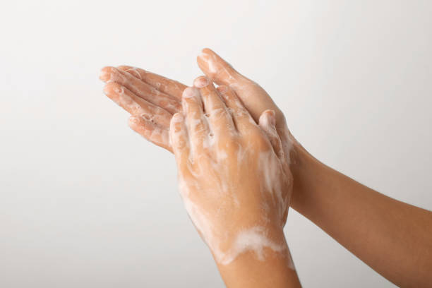 istock Child hands in soap bubbles against a grey wall 1359562287