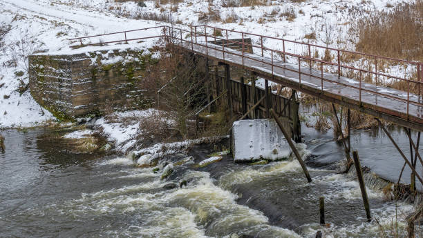 istock Boiling water in a winter river under a pedestrian bridge. Abstract background. Space for text. 1359562472