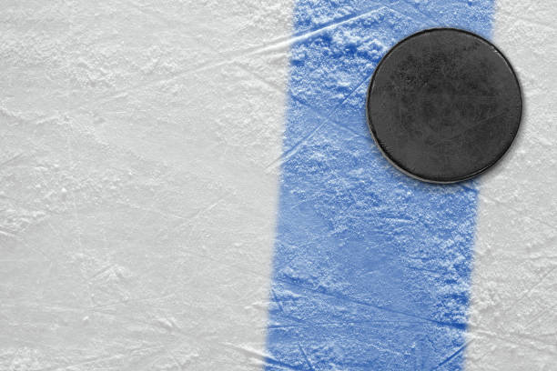 istock Ice hockey puck with blue line 1359563491