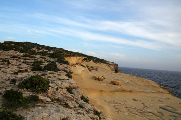 istock Eroded sandstone cliffs of Xlendi, Gozo, Malta 1359563646