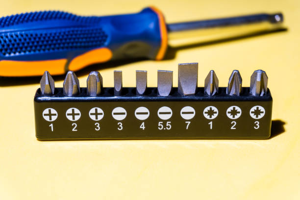 istock Set of screwdriver bits, on yellow background 1359564758