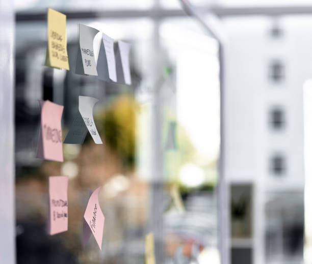 istock Closeup shot of sticky notes on a glass screen in an empty office 1359564879