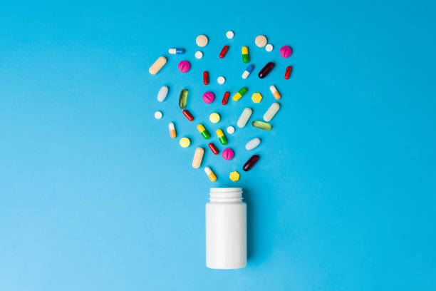 istock Medicine bottle with many tablets and capsules 1359565640
