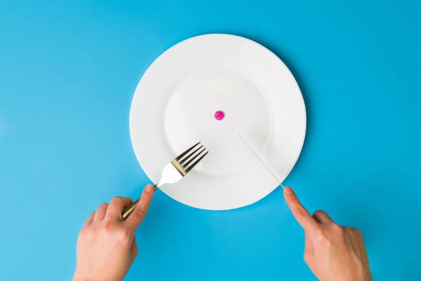 istock Person taking food supplements 1359565703