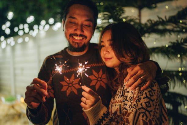 Asian Friends With Sparklers Enjoying Outdoor Party stock photo