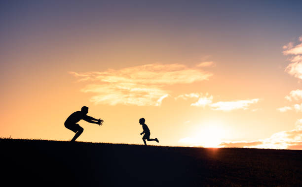 istock Father and son playing together in the park 1359565964