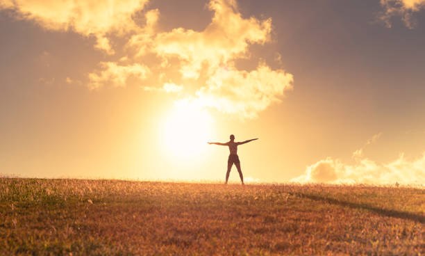 istock Woman exercising outdoors at sunset. 1359565989