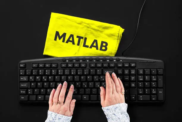 Photo of Rag width word matlab and hands on pc keyboard.