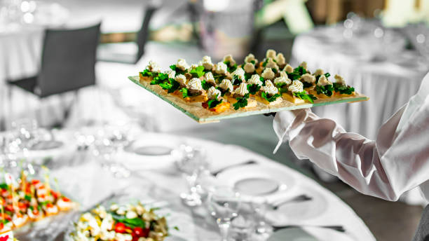 istock waiter holds tray with food. Restaurant service. buffet or catering. 1359566849