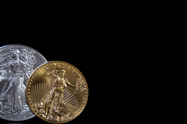 istock Silver and gold coin in lower left corner, with copy space 1359567887