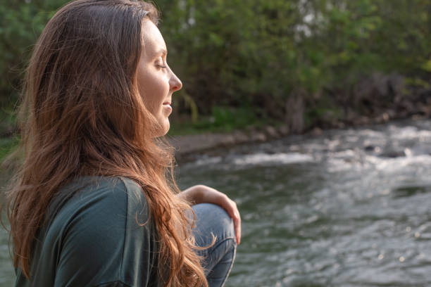istock Woman enjoying the warm sunlight in nature. 1359568430