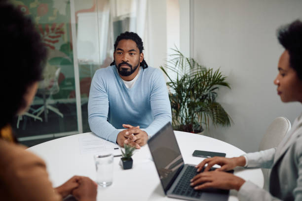 istock Young black candidate having job interview at business office. 1359569135