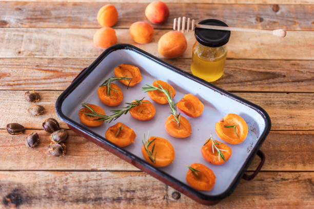 istock Raw apricot cut onto halves on baking tray 1359572637