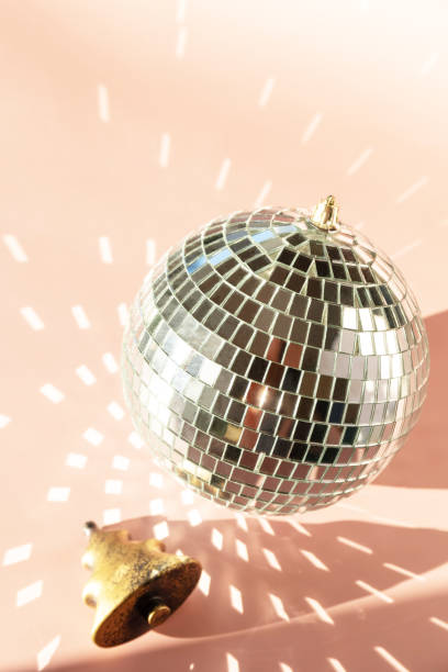 istock Minimal creative. Christmas decorations and mirror disco balls on sand color background. 1359573470