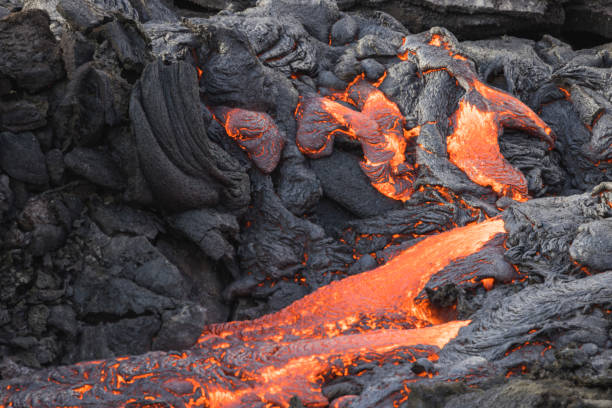 istock incandescent flowing volcanic lava in volcano 1359573762