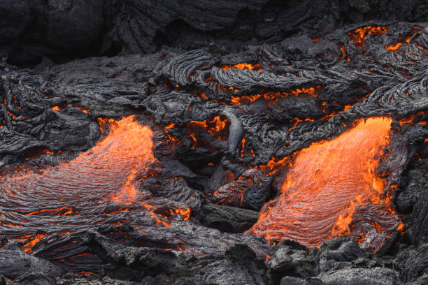 istock incandescent flowing volcanic lava in volcano 1359573767
