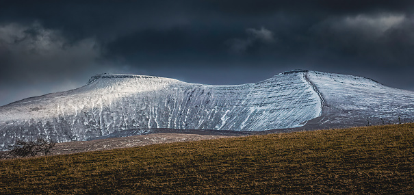 Snow covered Brecon Beacons mountains in South Wales, UK showing the twin summits of Penyfan and Corn Du