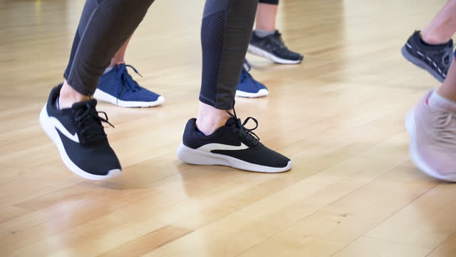 Feet of five women in dance exercise class