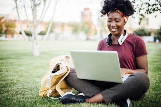 istock African American student enjoying in the park and studying 1359583141
