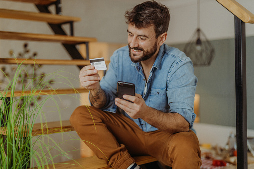 Young man using his credit card