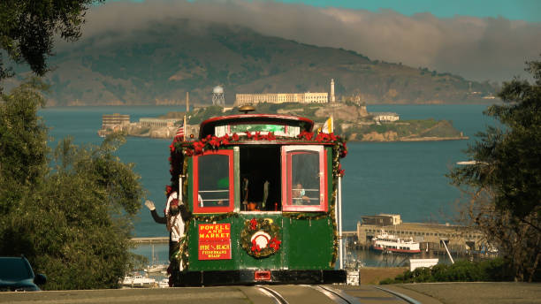 San Francisco, CA - December 16th, 2021: A cable car is driving up Hyde street hill.