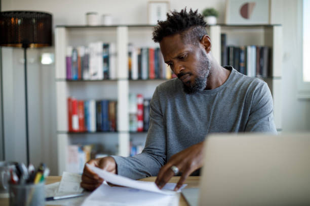 istock Worried man working at home 1359589516
